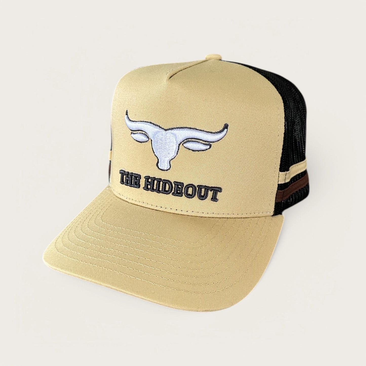 Beige and charcoal trucker cap with logo and photo under brim