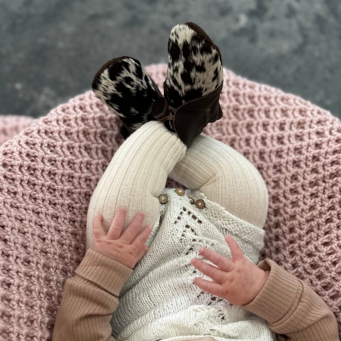 Cowhide and leather baby booties in brown and white
