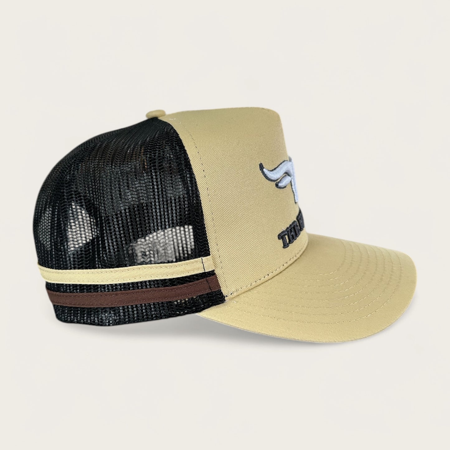 Beige and charcoal trucker cap with logo and photo under brim