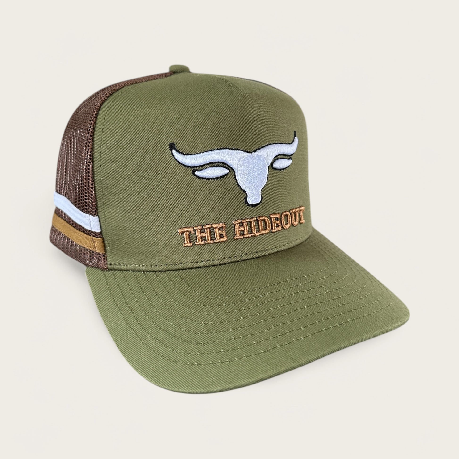 Green and brown trucker cap with logo and photo under brim