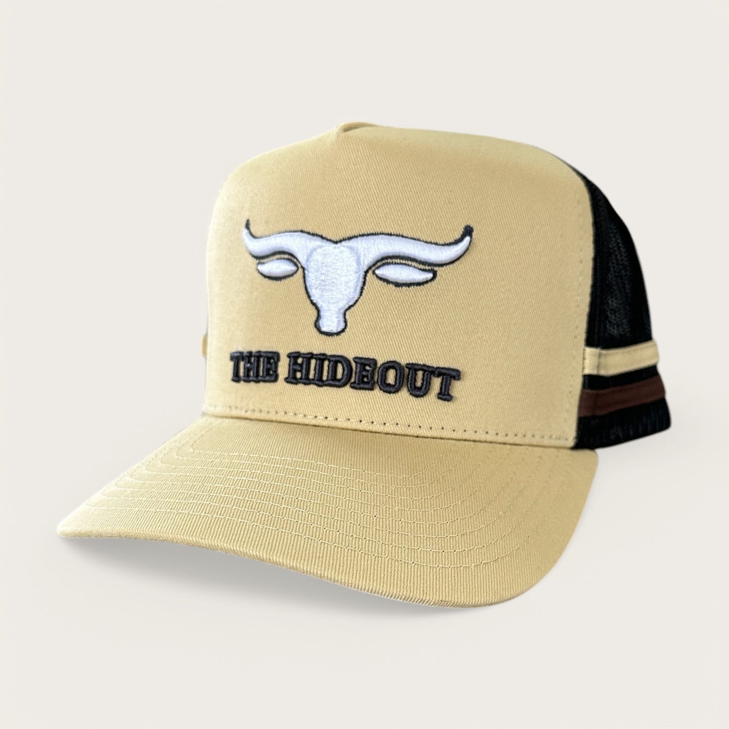 Beige and charcoal trucker cap with logo and photo under brim