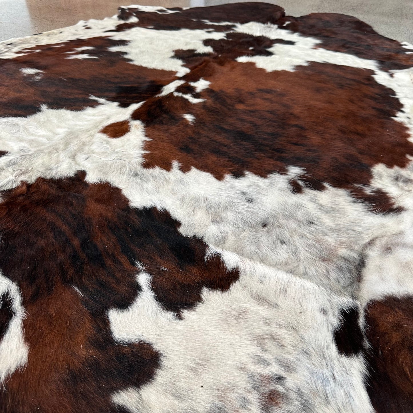Large premium cowhide rug in brown, black and white