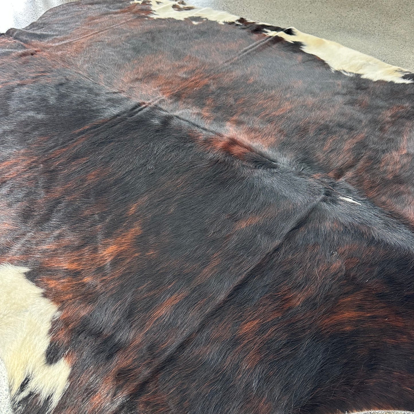 Large premium cowhide rug in brown, black and white