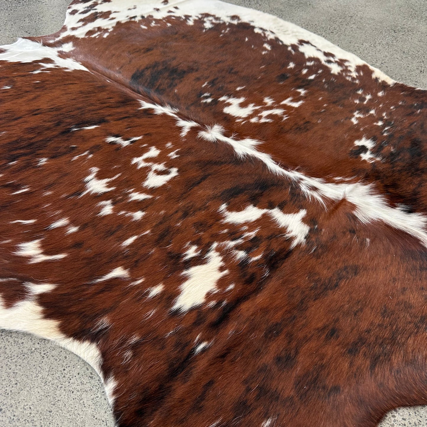 Large premium cowhide rug in brown, white and black