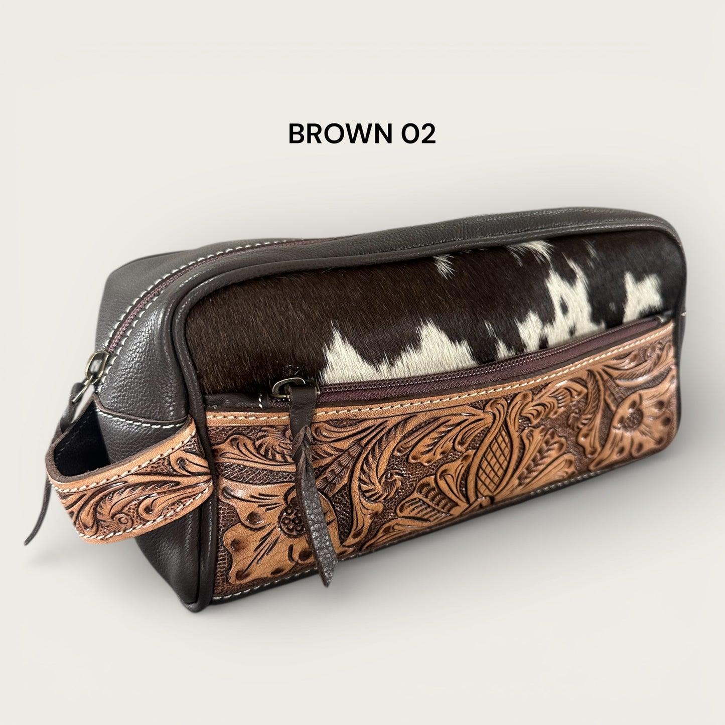Cowhide and leather toiletry bag in brown and white with tooling details