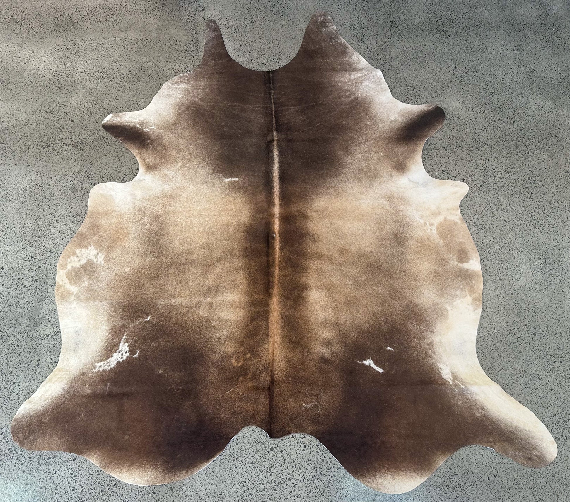 Large premium cowhide rug in brown and white