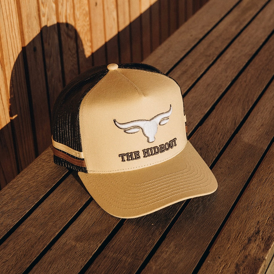 Beige and charcoal trucker cap with logo and photo under brim 