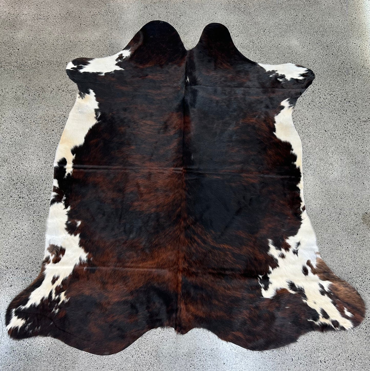 Large premium cowhide rug in brown, black and white 