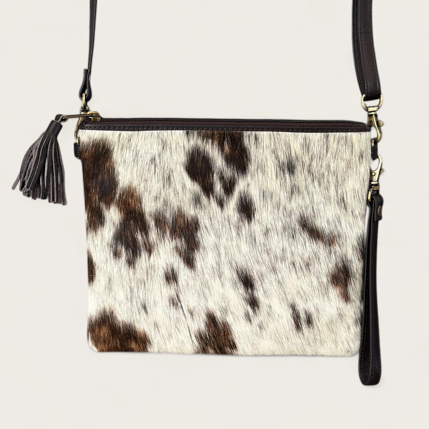 Cowhide and leather handbag or clutch in brown