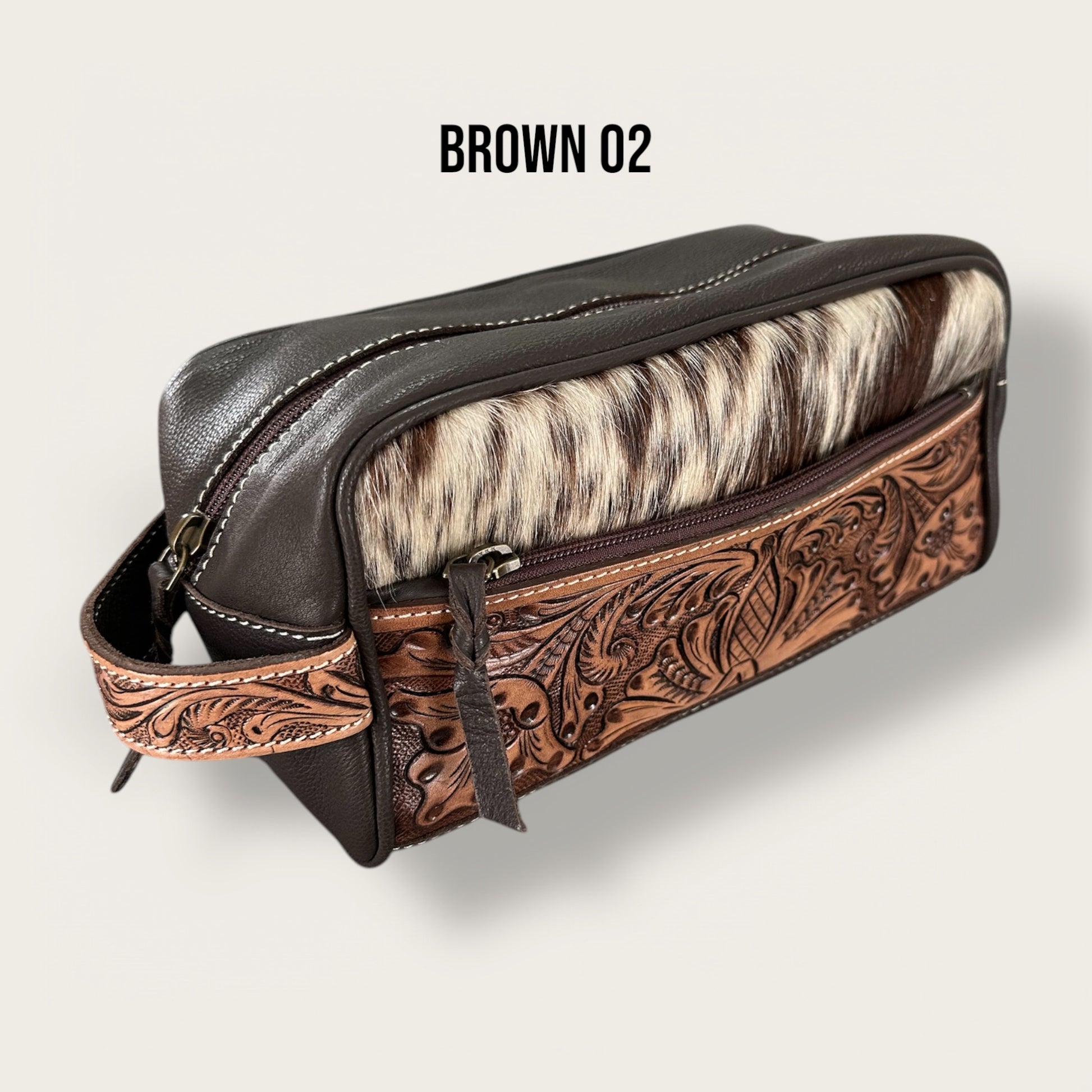 Cowhide and leather toiletry bag in brown and white with tooling details