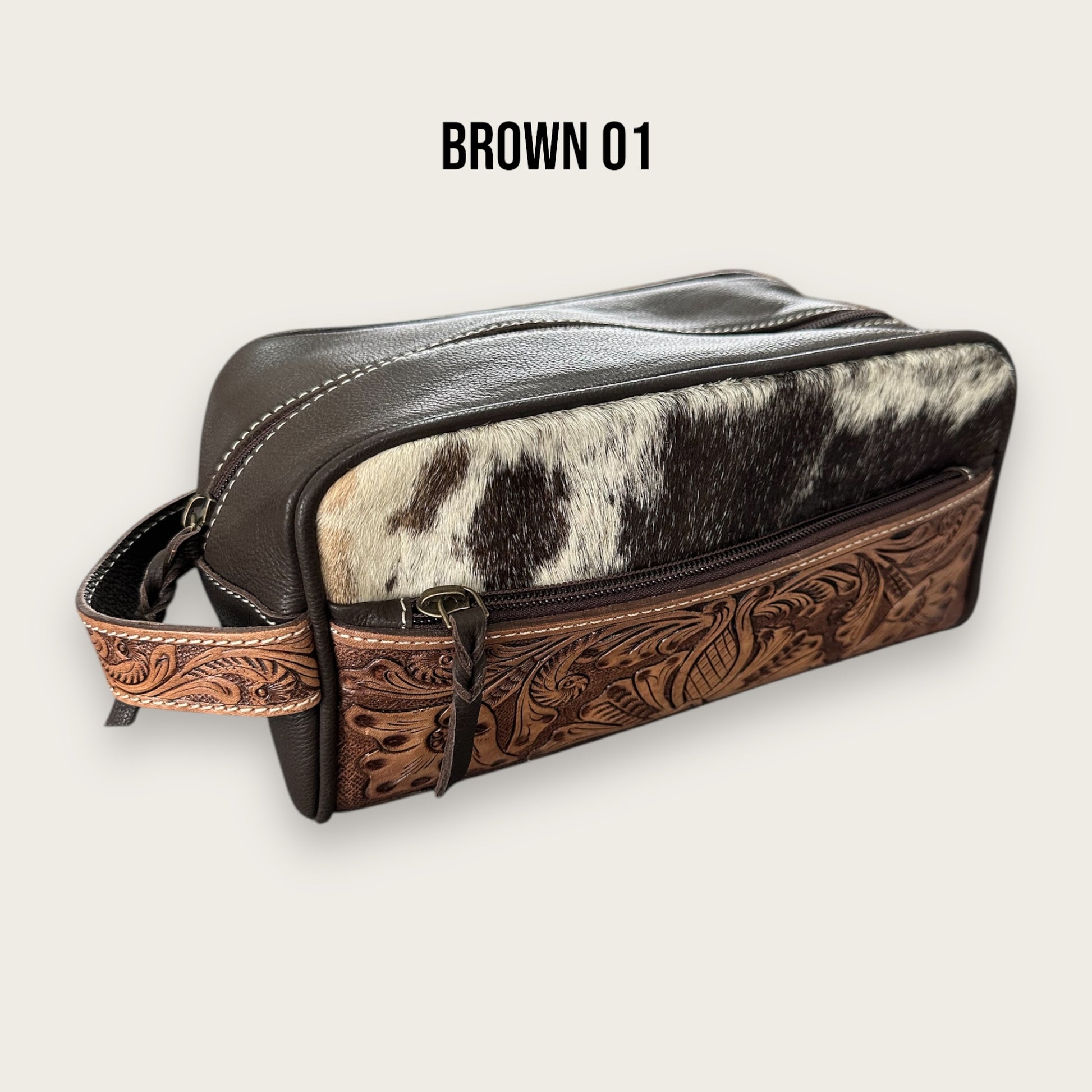 Cowhide and leather toiletry bag in brown and white with tooling details