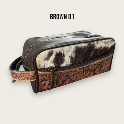 Cowhide and leather toiletry bag in brown and white with tooling details