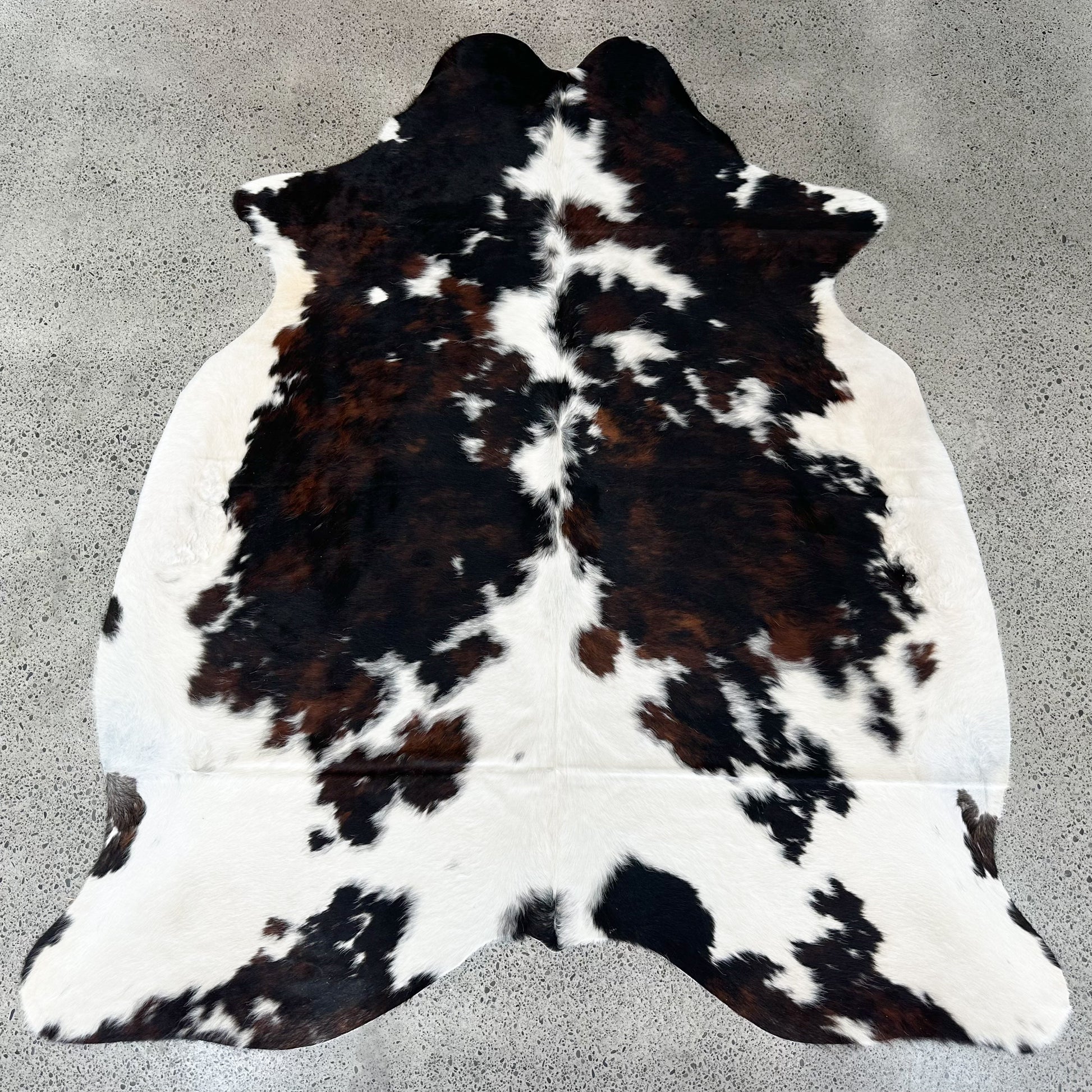 Large premium cowhide rug in black, brown and white