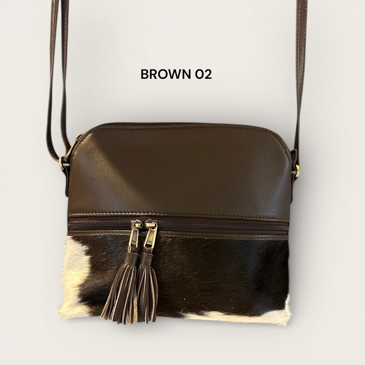 Cowhide and leather handbag in brown and white